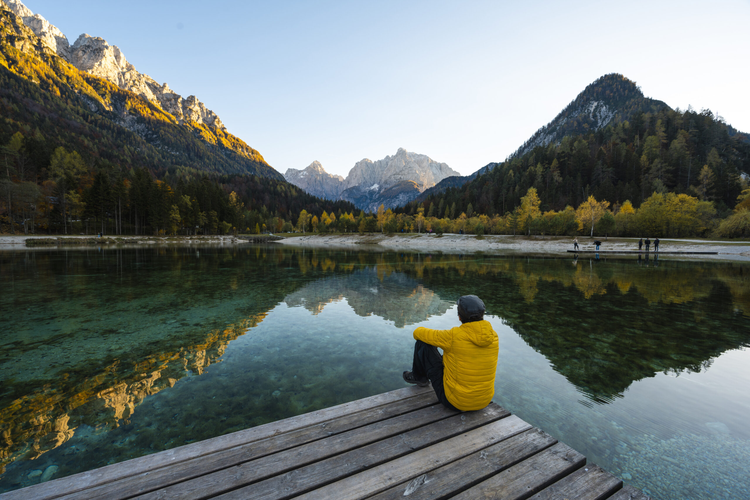 Person enjoying the view of a mountain lake