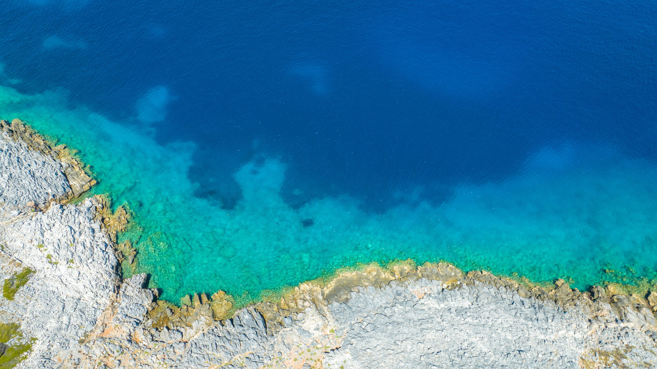 Top down aerial photo of rock coast and the sea